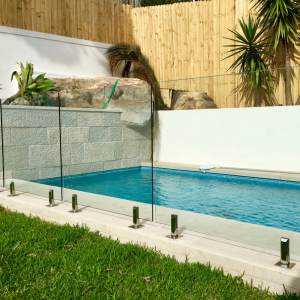 Frameless glass pool fence with polished chrome spigots Frameless glass pool fence with polished chrome spigots