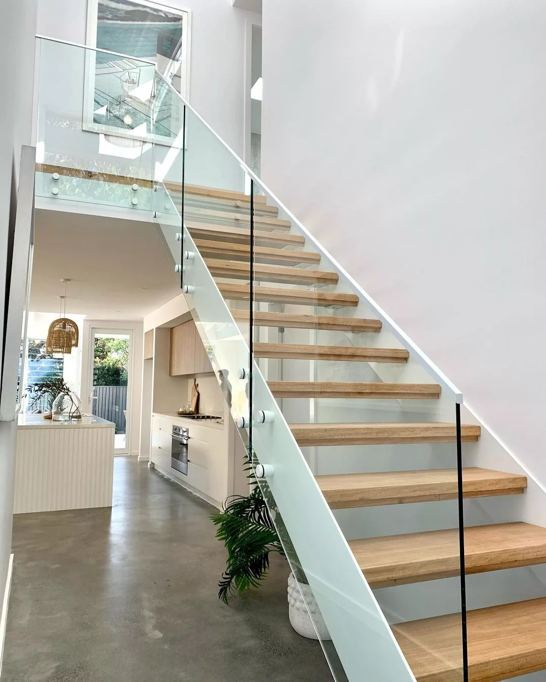 Face fix frameless stair balustrade with white hardware and top rail