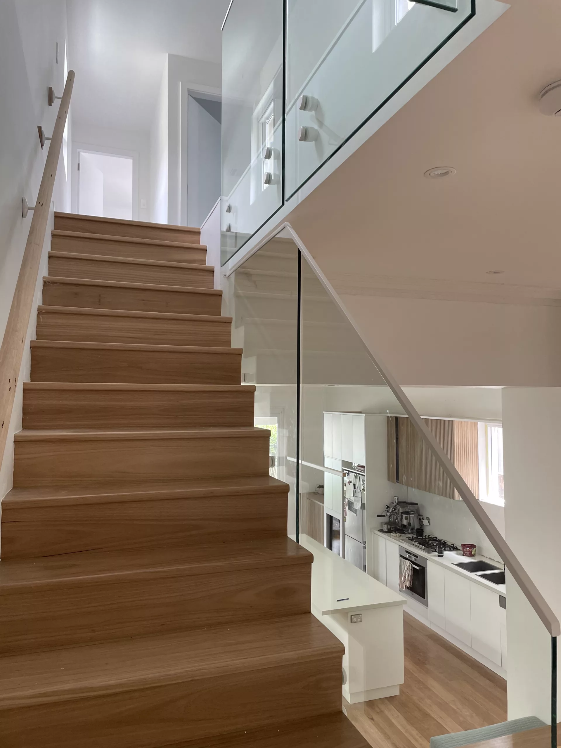 Stair glass balustrade with timber handrail